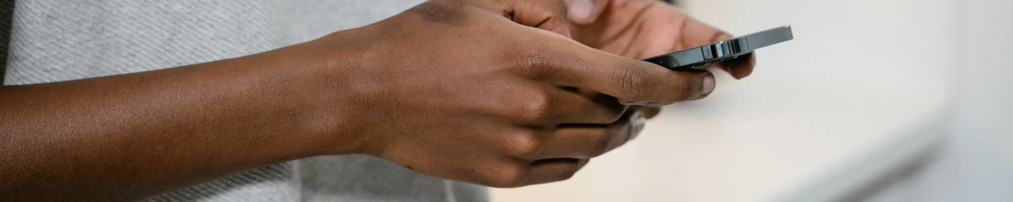 Close-up of hands holding a phone